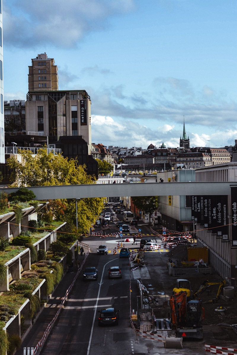 a city street filled with lots of traffic next to tall buildings